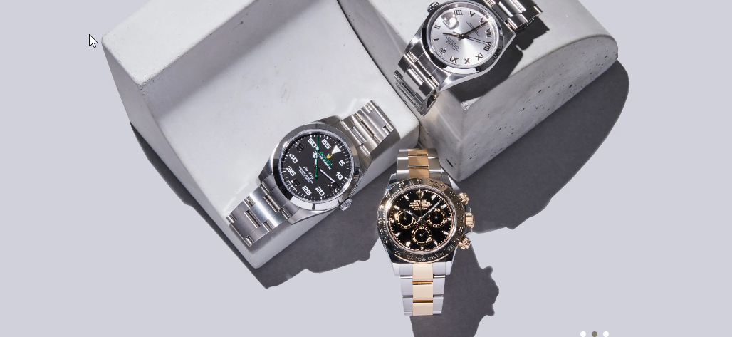 Three fine watches displayed in a sculptural still life